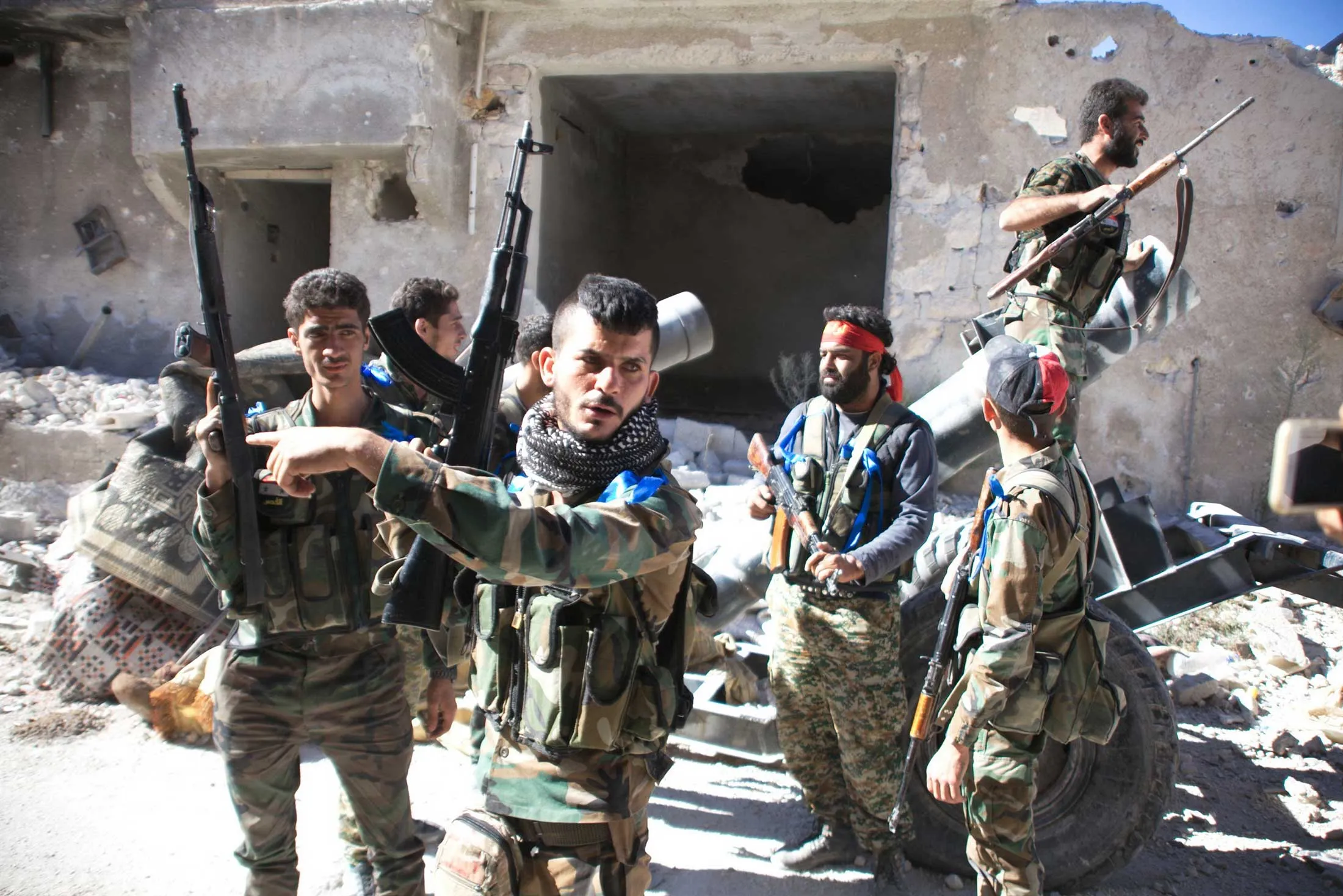 Syrian government forces gather in the largely deserted Palestinian refugee camp of Handarat, north of Aleppo, on September 24, 2016 after they captured the area following multiple Russian air strikes.
