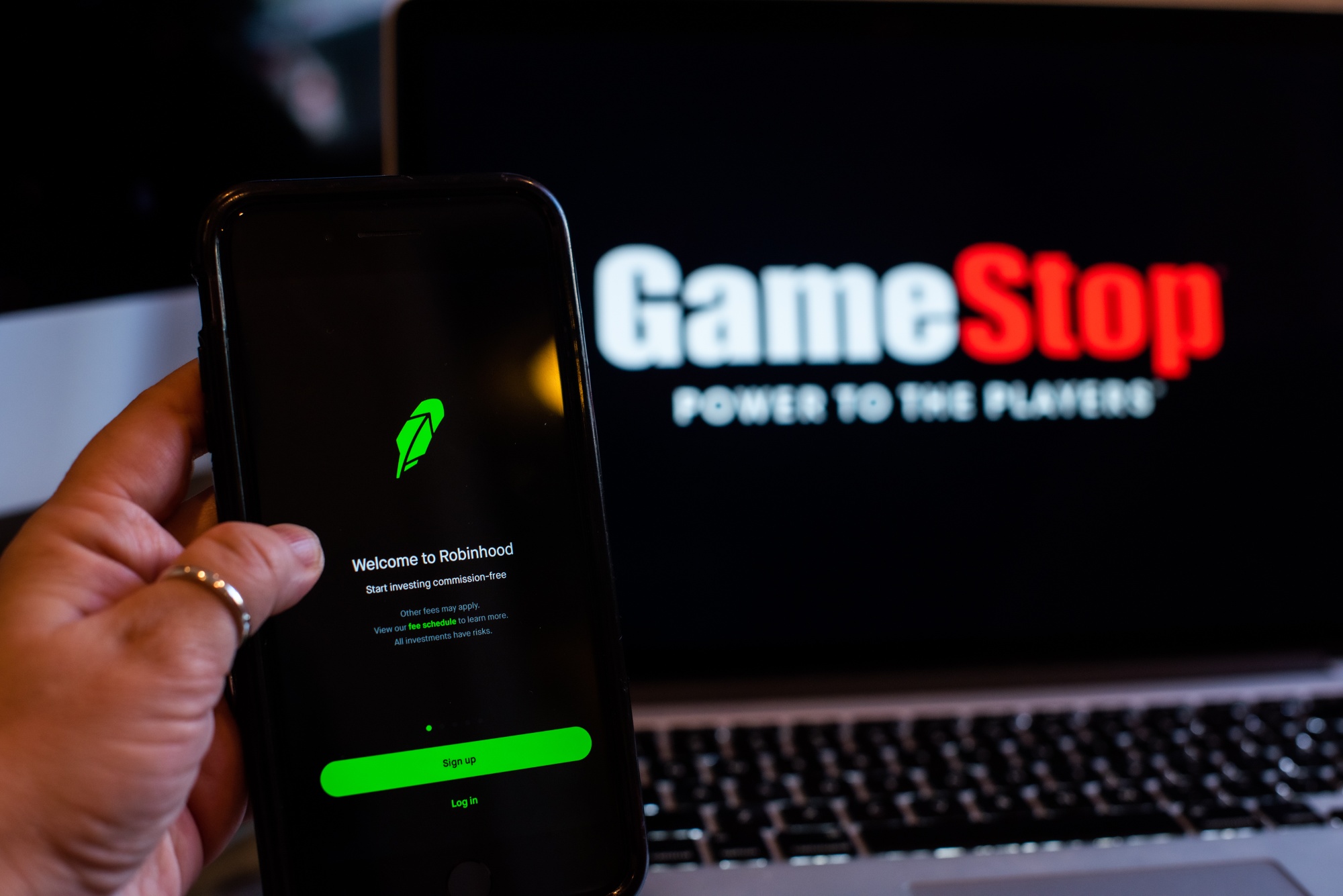 The GameStop Corp. logo on a laptop computer and Robinhood application on a smartphone arranged in Hastings-On-Hudson, New York, U.S., on Friday, Jan. 29, 2021. GameStop Corp. advanced on Friday and was on track to recoup much of Thursday’s $11 billion blow after Robinhood Markets Inc. and other brokerages eased trading restrictions on the video-game retailer.