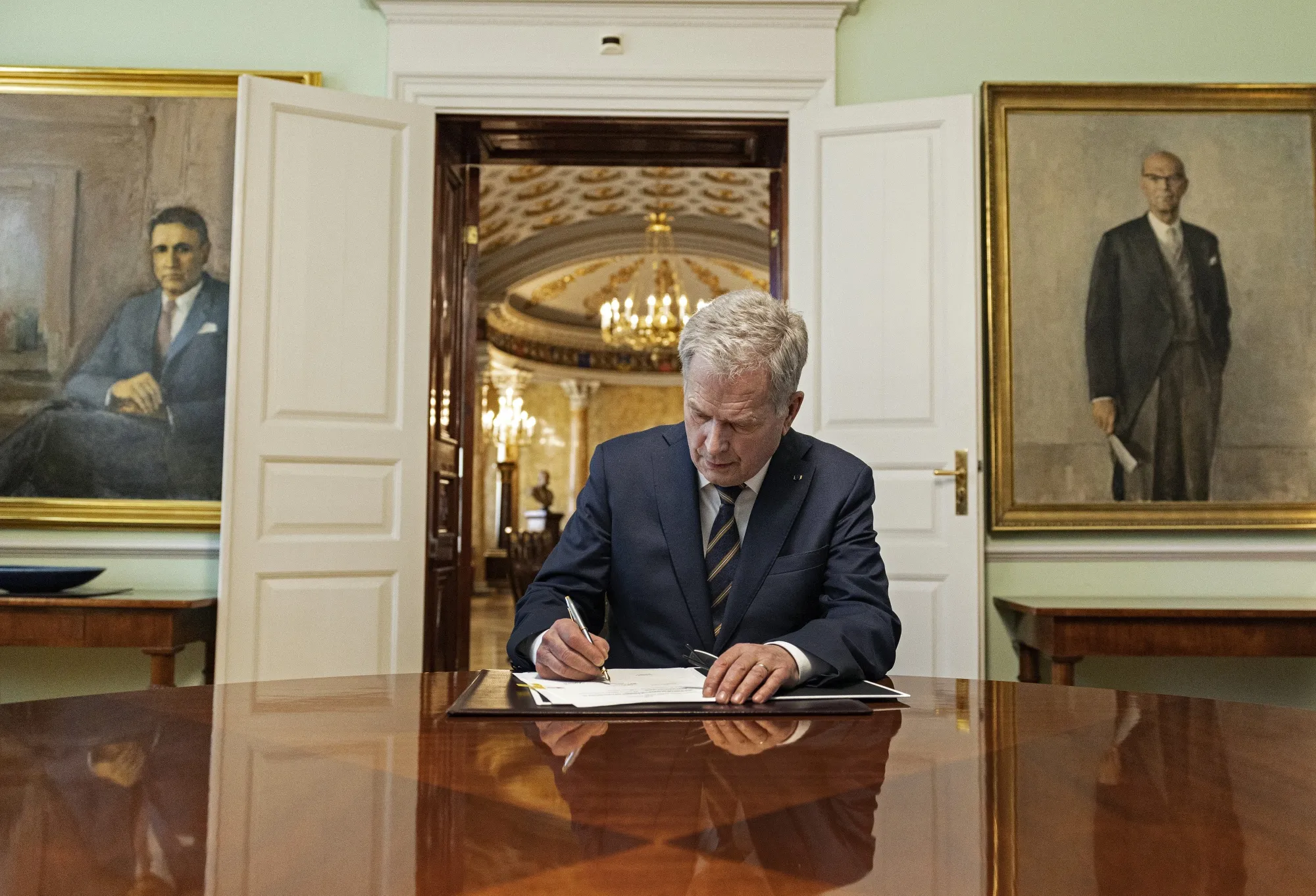 Sauli Niinisto signs Finland’s NATO legislation, in Helsinki, on March 23.