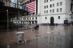 A food delivery worker wearing a protective mask bikes past the New York Stock Exchange on April 21.