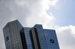 Logos sit on the Deutsche Bank AG headquarters in Frankfurt, Germany, on Monday, March 18, 2019.