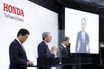 Toshihiro Mibe, president and chief executive officer of Honda Motor Co., center