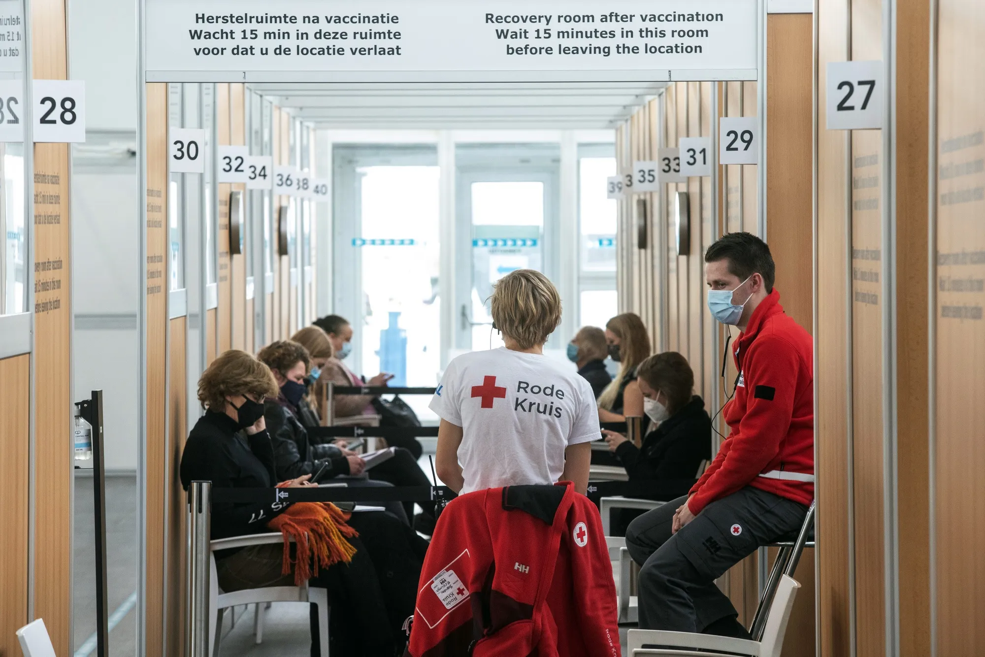 Members of the Dutch Red Cross wait in an area after receiving a dose of the AstraZeneca vaccine in Amsterdam, on Feb. 23.