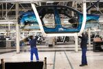 Employees work on a body shell at the production line at the Stellantis auto manufacturing plant in Sochaux, France. Photographer: Nathan Laine/Bloomberg