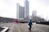 A delivery worker walks through a near deserted parking lot in Beijing, China, on Sunday, Feb. 2, 2020.