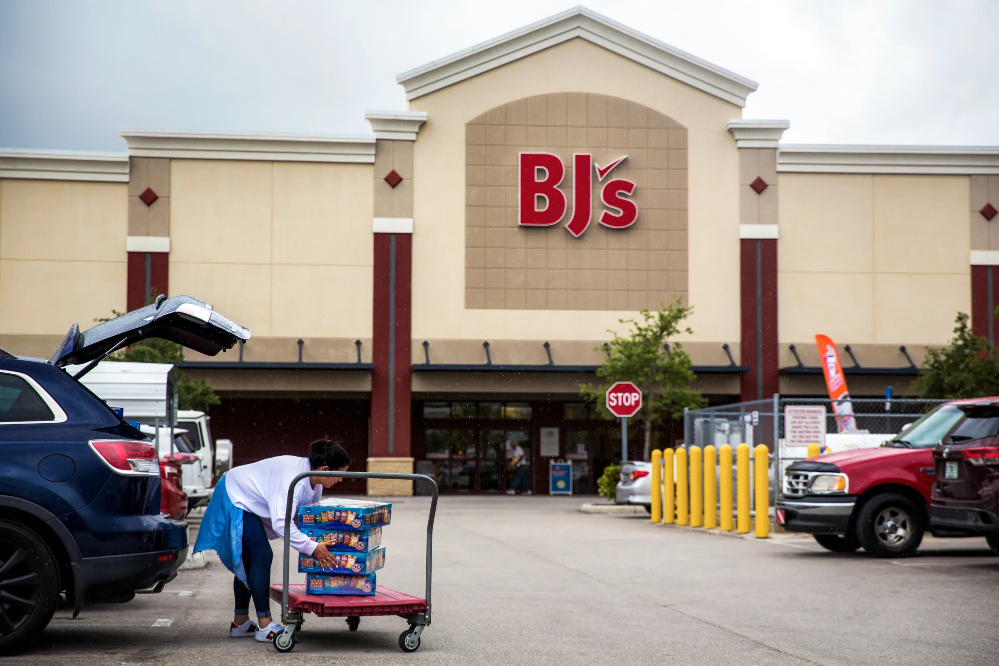 A customer loads groceries into the trunk of a vehicle outside a BJ's Wholesale Club&nbsp;in Miami.