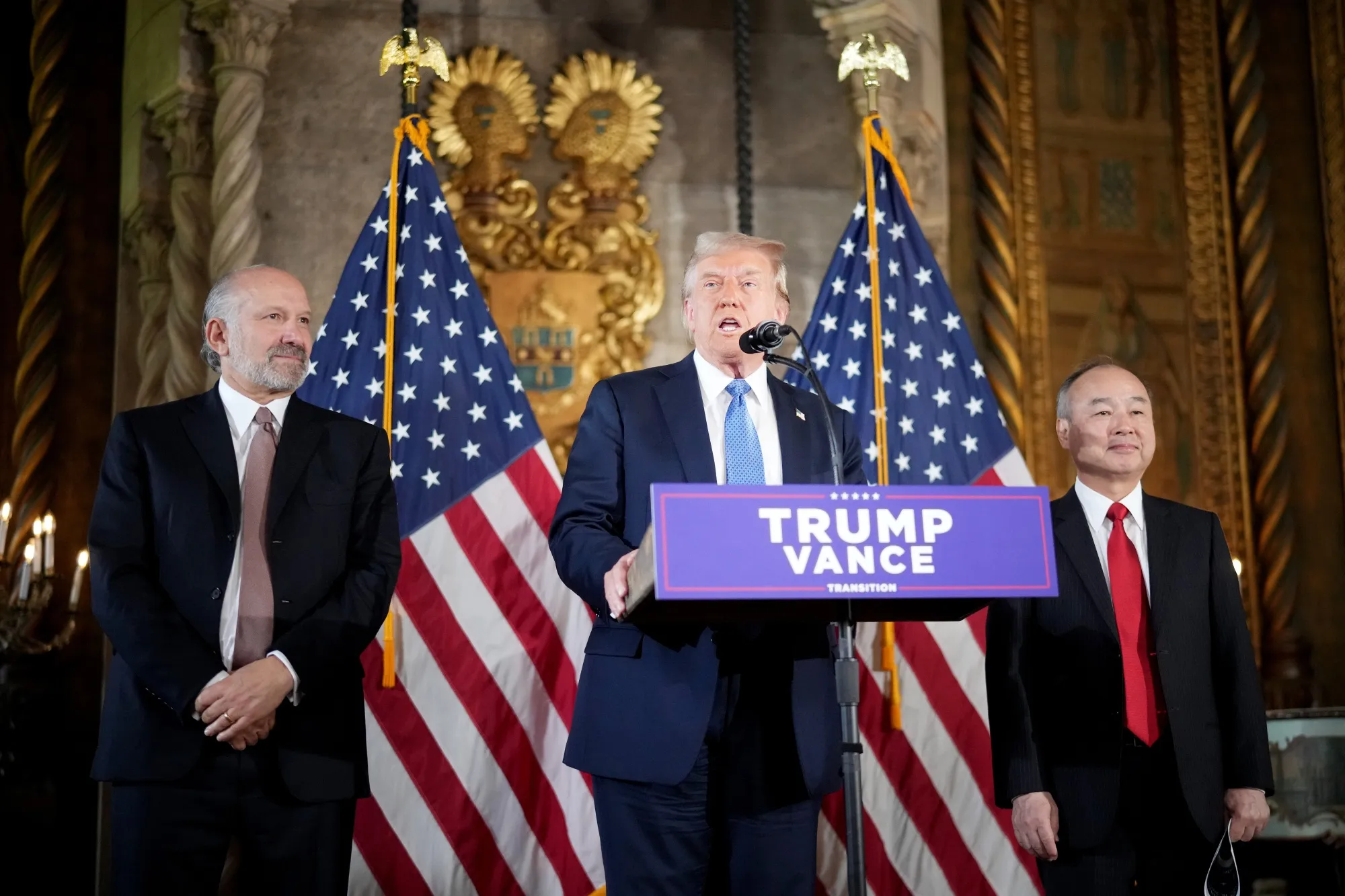 Donald Trump delivers remarks alongside Howard Lutnick, left, and Masayoshi Son at the Mar-a-Lago resort in Palm Beach, Florida, on Dec. 16.