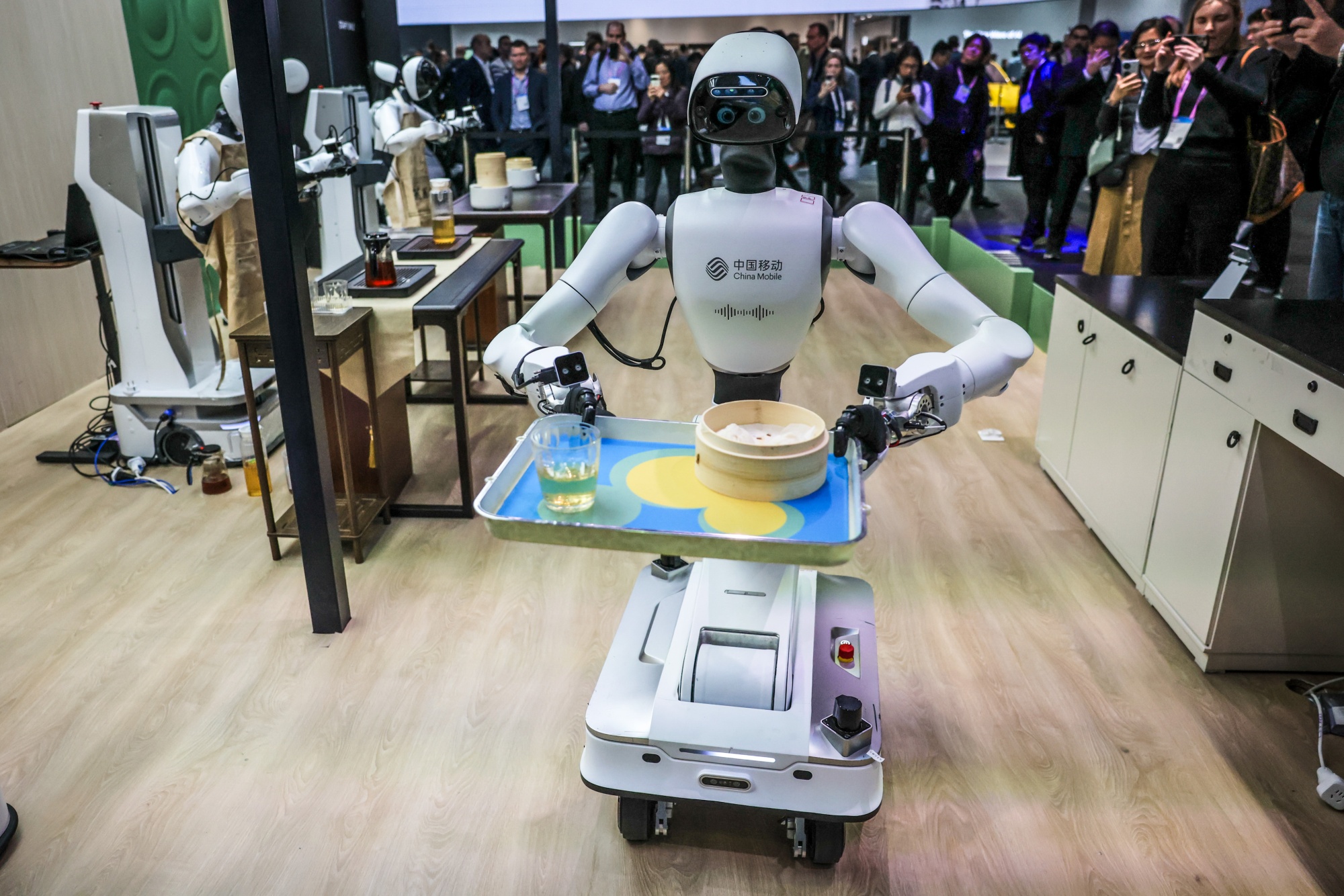 A demonstration of a Robot Restaurant on the China Mobile pavilion at MWC Barcelona 2026 in Barcelona, Spain, on Tuesday, March 3, 2026. This year's edition of MWC is heavily geared toward AI and establishing best practices to leverage it to drive sales and wider adoption. Photographer: Angel Garcia/Bloomberg