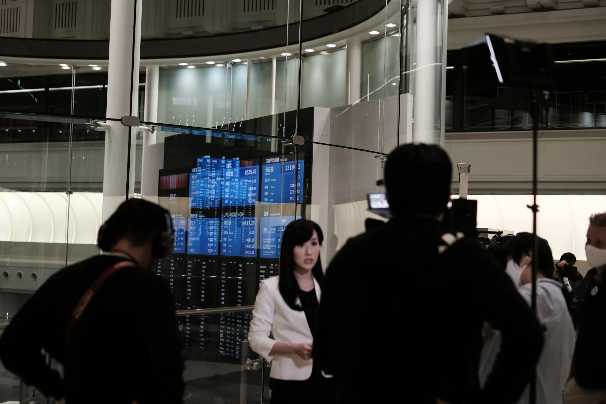 Members of the media work near a screen displaying share prices inside the Tokyo Stock Exchange following a hardware breakdown at the exchange on Oct. 1.