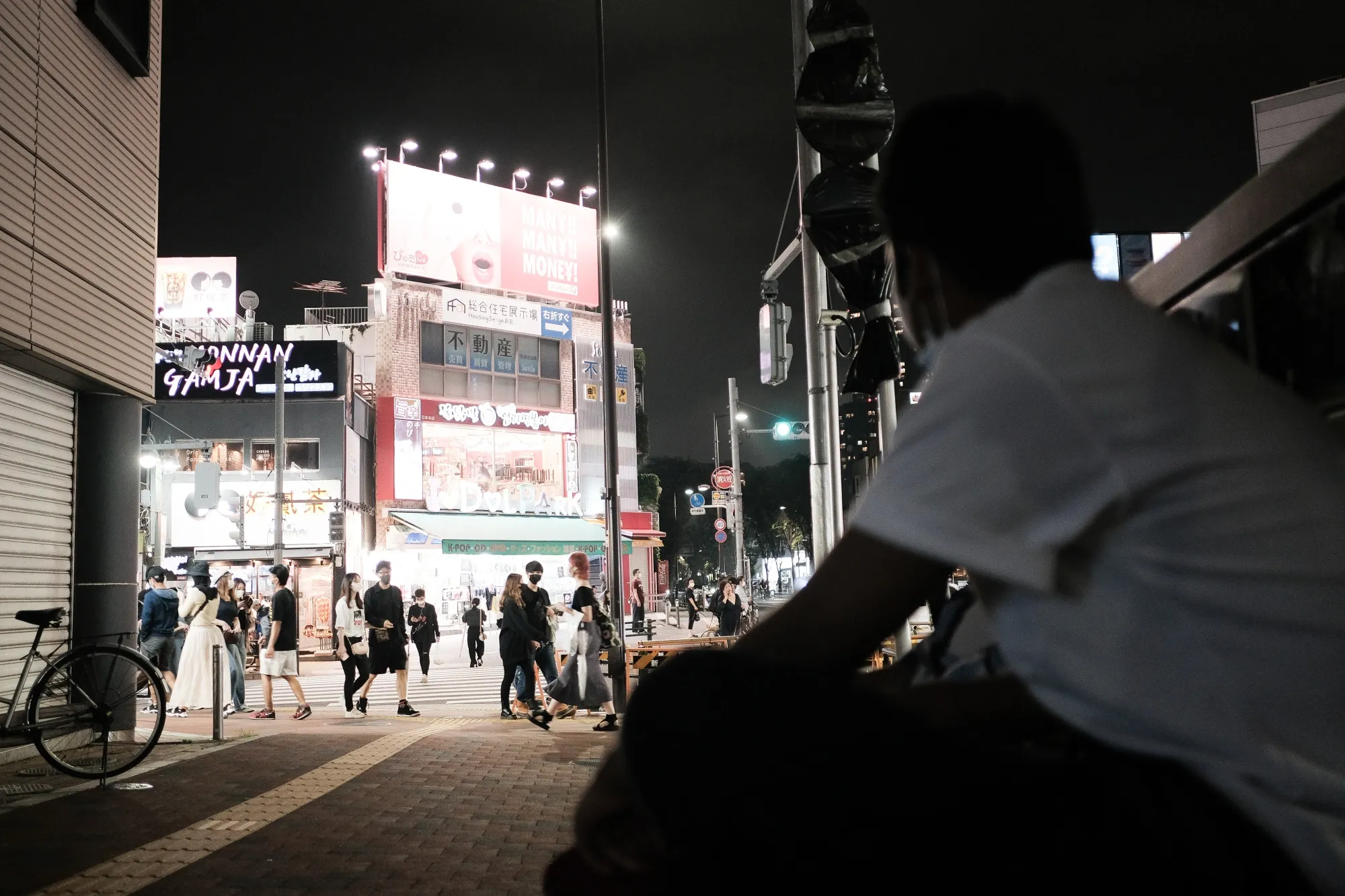 People walk past a grocery store in the Shinjuku district of Tokyo on June 14.