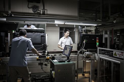 Workers assemble televisions at a TCL Corp. plant in Huizhou.