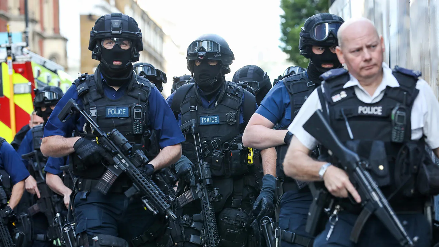 Armed police officers patrol streets near the scene of a terror attack in London, U.K., on Sunday, June 4, 2017. A van swerved into Saturday-night crowds on London Bridge, before three men got out and went on a stabbing rampage through nearby bars.
