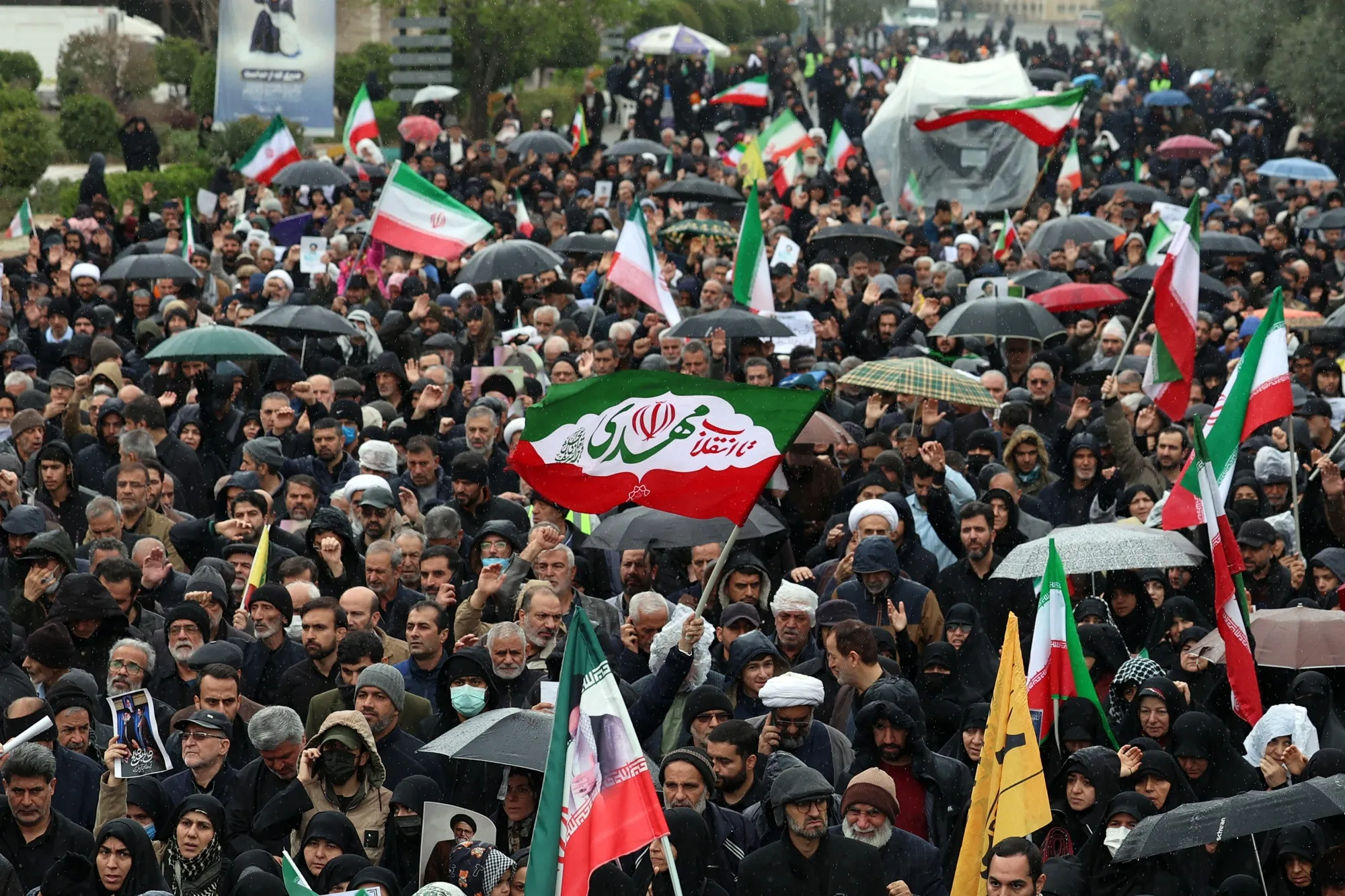 Mourners march during the funeral ceremony for Iran's slain intelligence minister Esmail Khatib and his family in Tehran on March 20.