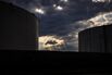 Fuel Storage Tanks Under A Dramatic Sky