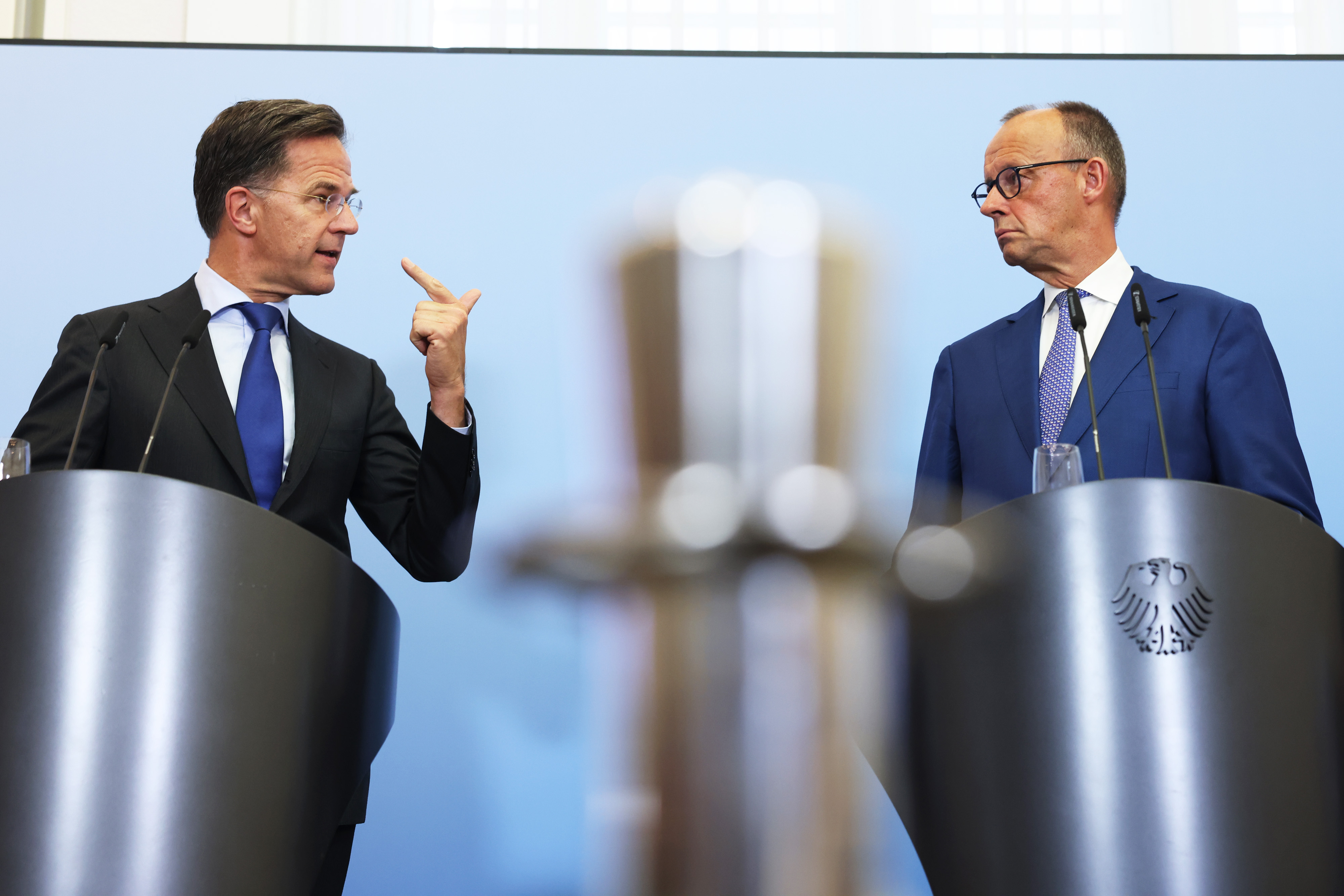 Mark Rutte, secretary general of the North Atlantic Treaty Organization (NATO), left, and Friedrich Merz, Germany's chancellor, at a news conference following a cabinet meeting in Berlin, Germany, on Wednesday, July 1, 2026. Germany is seeking co-operation with the US on weapons production. Photographer: Krisztian Bocsi/Bloomberg