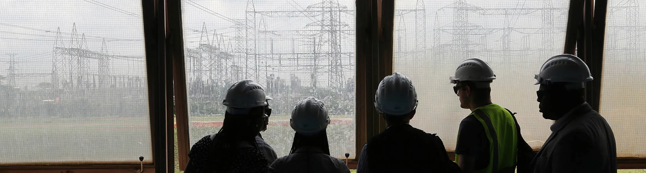 Visitors look at electricity pylons carrying power lines at the newly renovated energy generation plant, operated by Egbin Power Plc, in Lagos, Nigeria, on Wednesday, Aug. 26, 2015. While Nigeria was the world's fourth-biggest exporter of liquefied natural gas in 2012, it's struggling to meet local demand for the fuel used by plants that generate at least 70 percent of the country's electricity needs.
