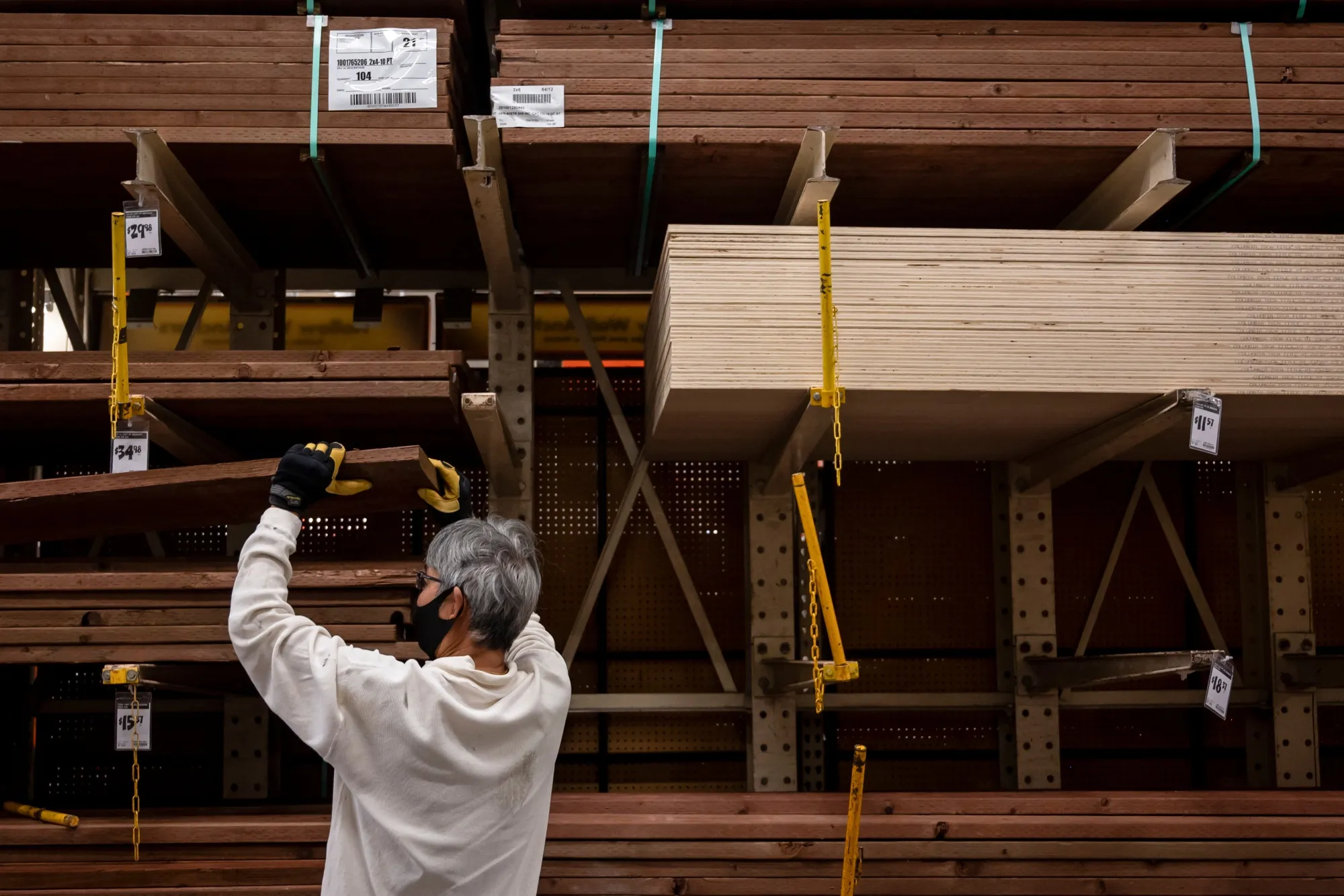 A customer wearing a protective mask views lumber for sale at a Home Depot Inc. store in Daly City.