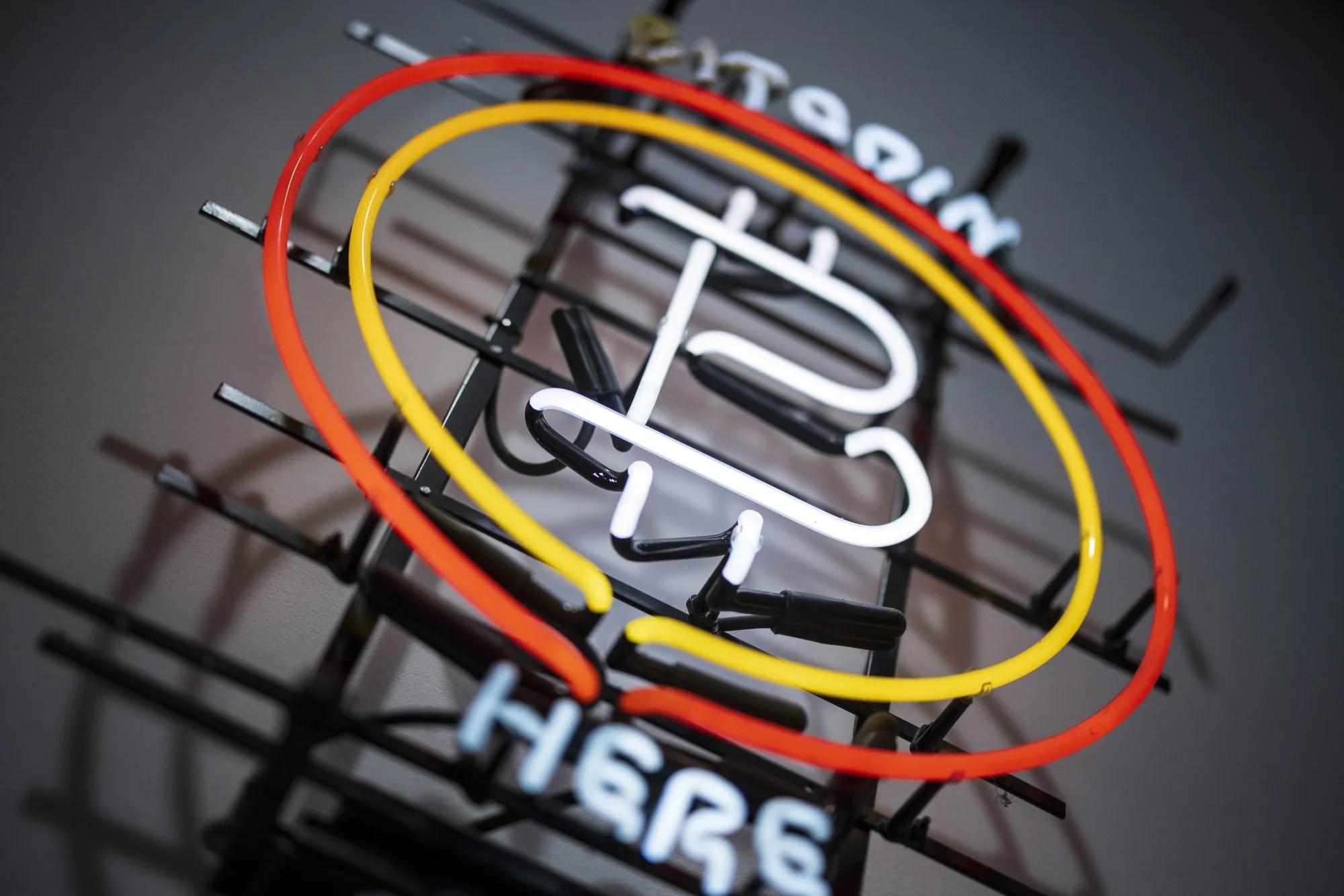 A neon Bitcoin sign inside a store in Prague.