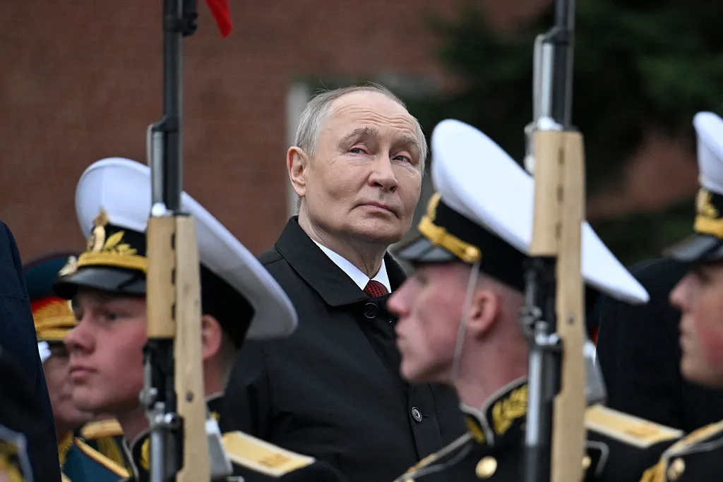 Vladimir Putin attends a ceremony to lay flowers at the Tomb of the Unknown Soldier by the Kremlin wall.