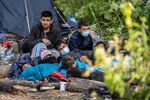 Migrants at a makeshift encampment on the border between Belarus and Poland.