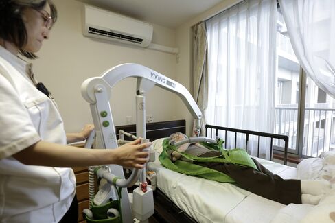 An automated lift moves an elderly at a private nursing home in Chiba