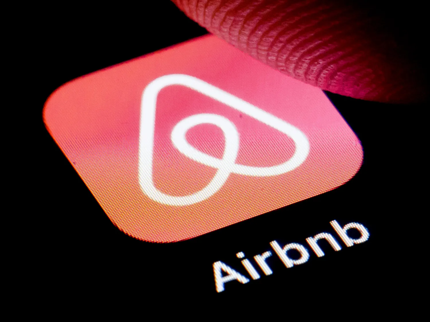 Photo illustration Airbnb logo&nbsp;displayed on a smartphone.