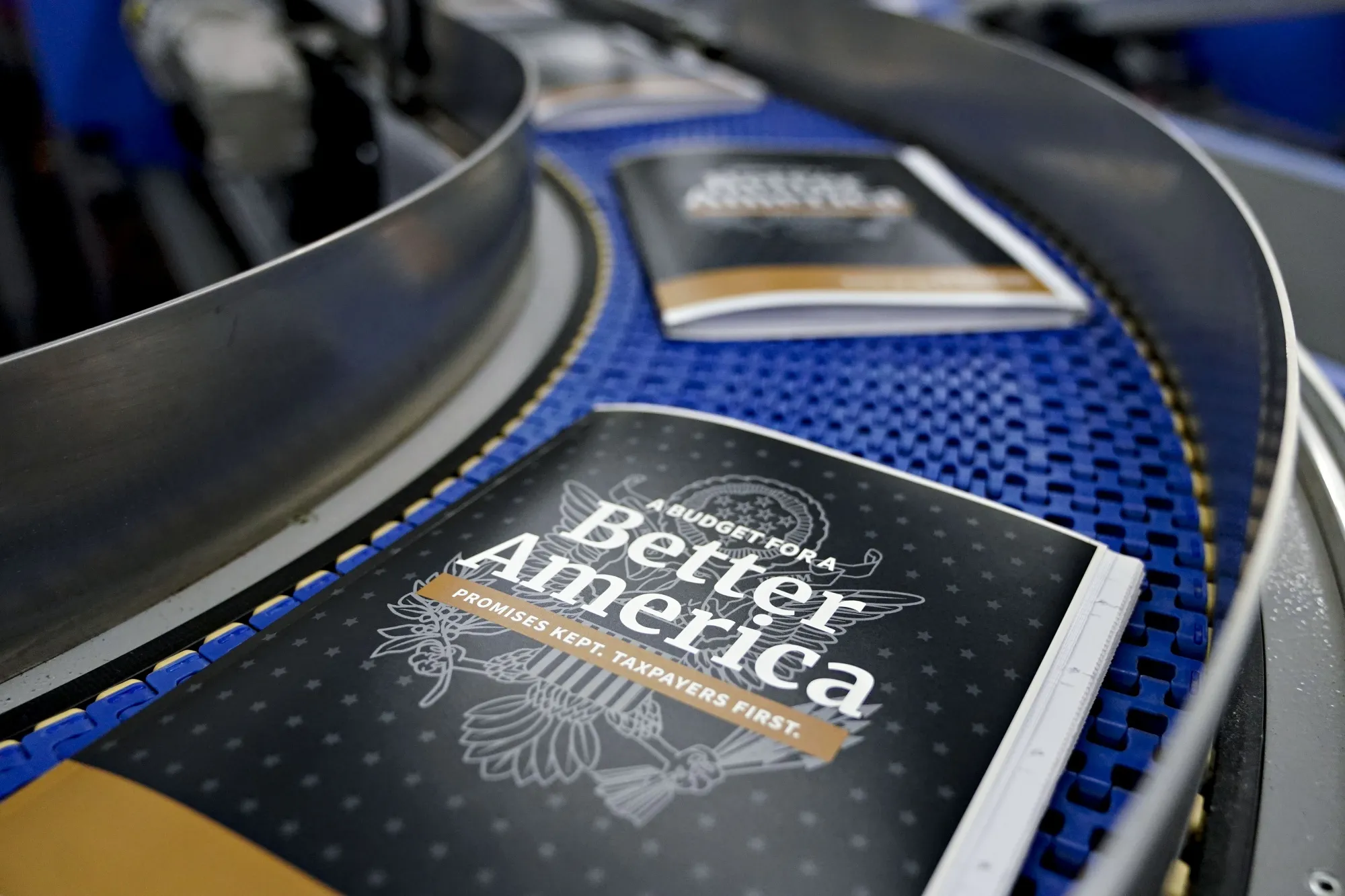 Copies of the fiscal year 2020 budget sit on a conveyor belt inside the Government Publishing Office&nbsp;in Washington, D.C., U.S., on&nbsp; March 7.&nbsp;