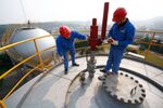 Employees conduct routine checks at a gas storage in Suining, Sichuan province.
