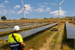 Wind turbines near a solar farm in Avila, Spain. Photographer: Emilio Parra Doiztua/Bloomberg