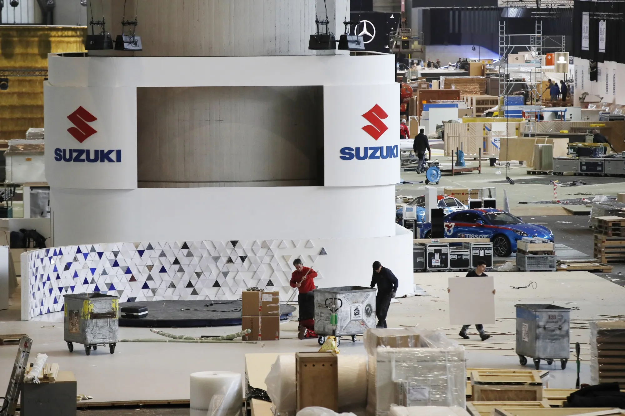 Workers dismantle stalls and pack crates at the cancelled Geneva International Motor Show on Feb. 29, 2020.