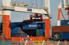 A gantry crane carries a Sinokor Merchant Marine Co. container at a shipping terminal in Yokohama, Japan, on Monday, Feb. 18, 2019. Japan is sticking to its view that the U.S. won’t apply higher tariffs on imports of Japanese cars and auto parts so long as negotiations toward a trade deal continue, according to Tokyo’s lead negotiator with Washington. Negotiations over a trade deal announced last September by Trump and Abe have yet to start, partly due to ongoing talks between Washington and Beijing.
