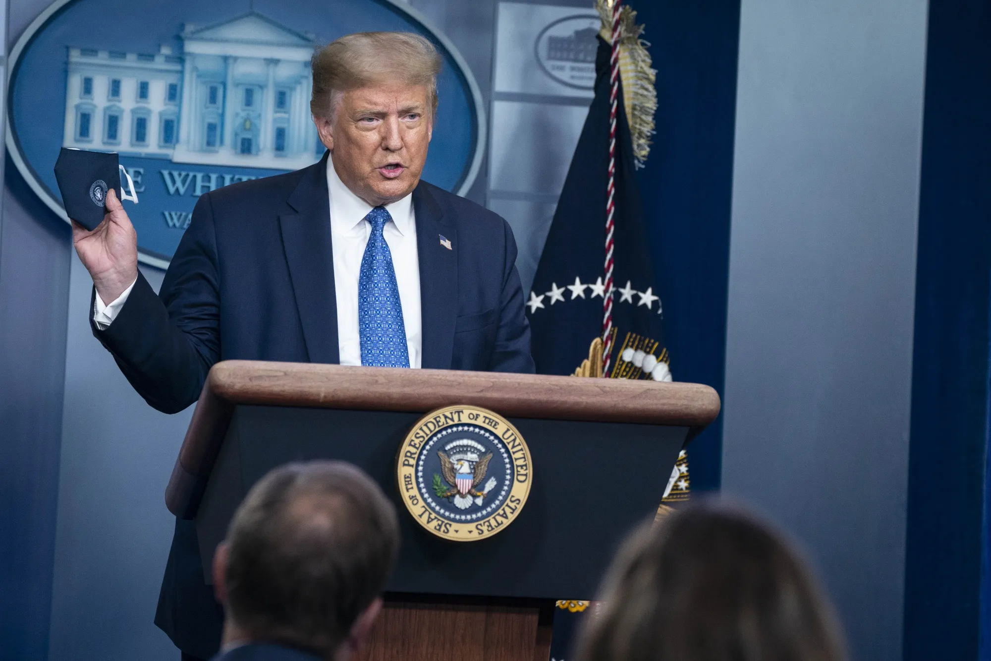 Donald Trump holds a face mask during a news conference on July 22.