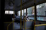 A commuter wearing a protective mask sits on an empty bus in Buenos Aires.