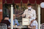 A waiter serves customers outside at a cafe in Moscow.