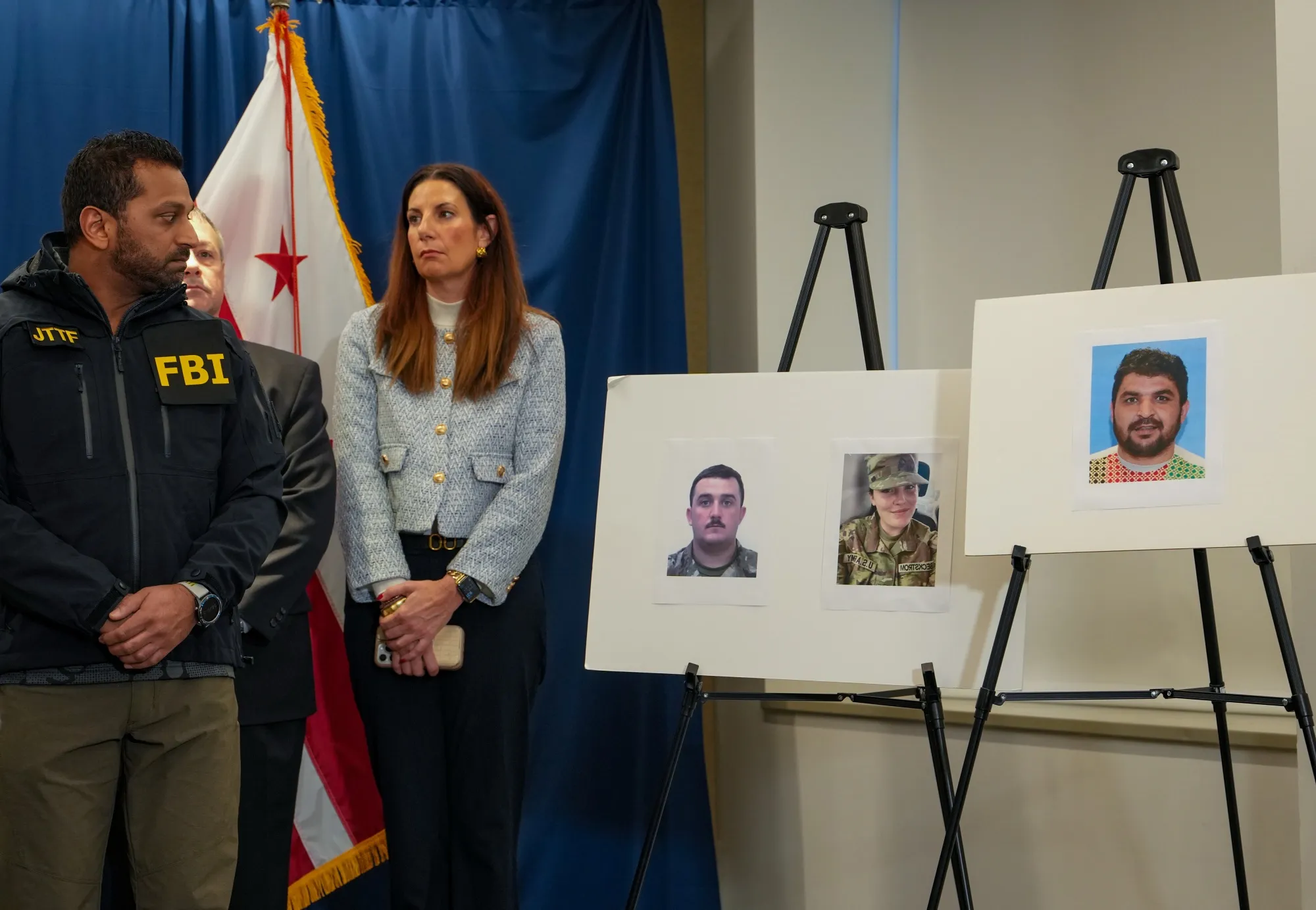 FBI Director Kash Patel looks at photos of the two West Virginia National Guard soldiers shot, left, along with the suspect in the shooting, right, in Washington&nbsp;on Nov. 27.&nbsp;