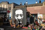 A woman poses for a photo in front of a&nbsp;George Floyd&nbsp;mural in Minneapolis last year on the first anniversary of his murder at the hands of the&nbsp;city’s police.&nbsp;