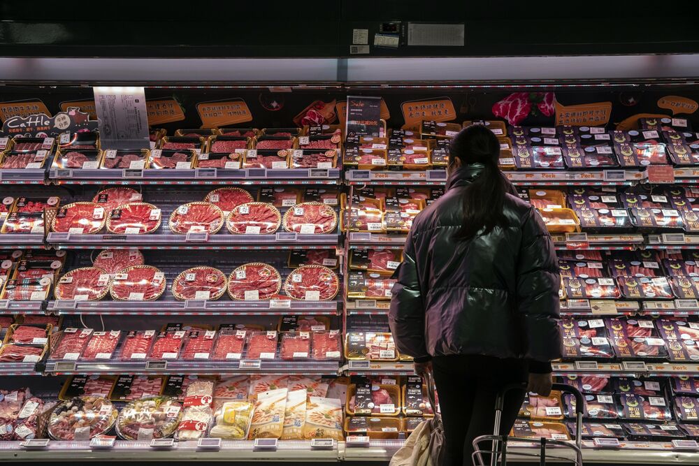 A customer looks at imported meat at an Ole supermarket in Shanghai, on Jan. 19. In Beijing and Shanghai, supermarkets are required to have separate shelves and sections for imported frozen food to avoid cross contamination.