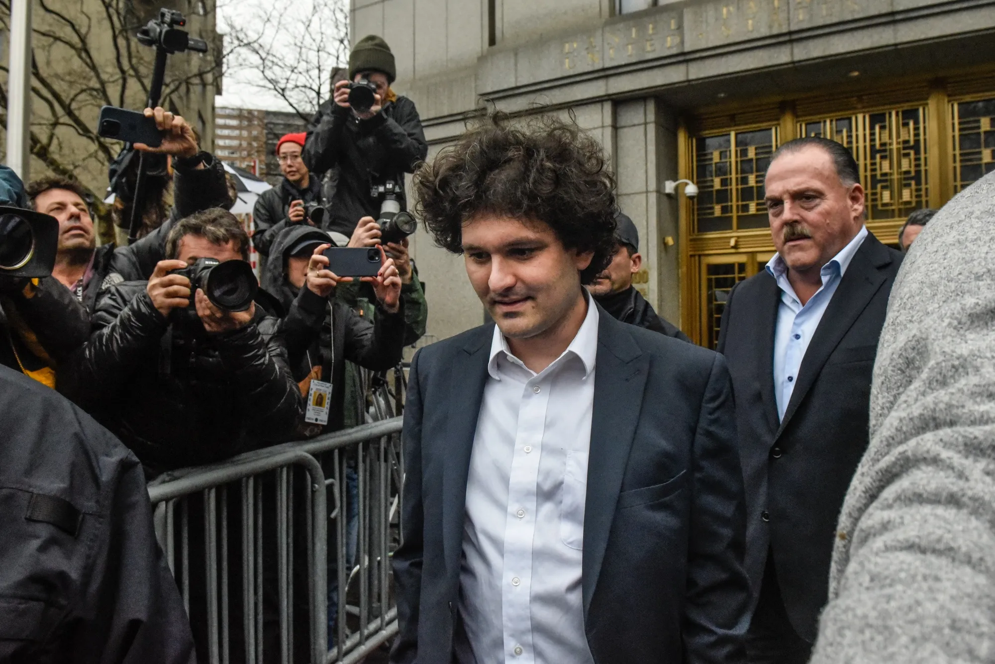 Sam Bankman-Fried, center, departs from court in New York on Jan. 3.