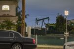 Pump jacks draw crude oil from the Long Beach Oil Field near homes in Signal Hill, California.