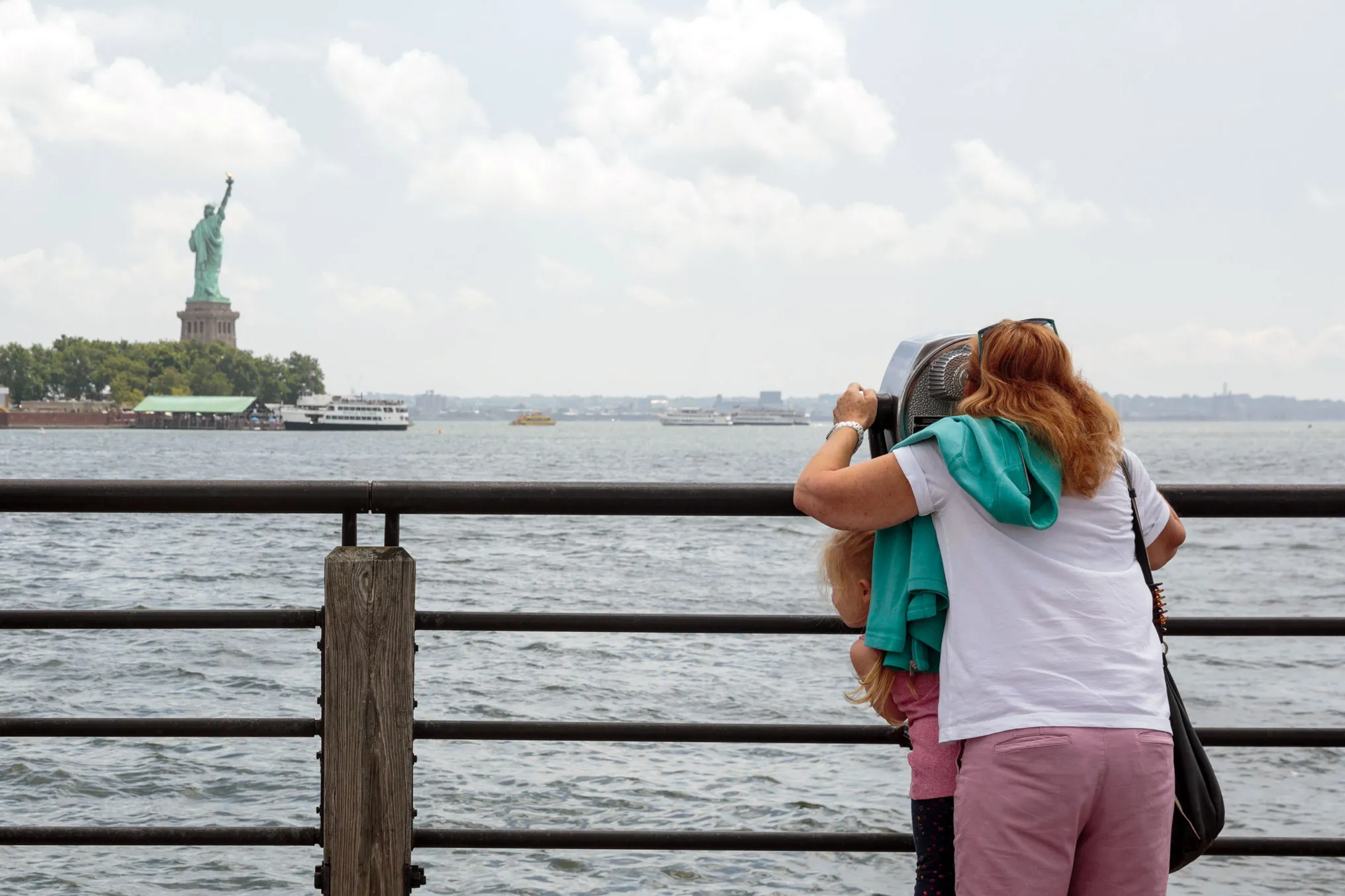 Visitors look at the Statue of Liberty from Liberty State Park, on Aug. 14.