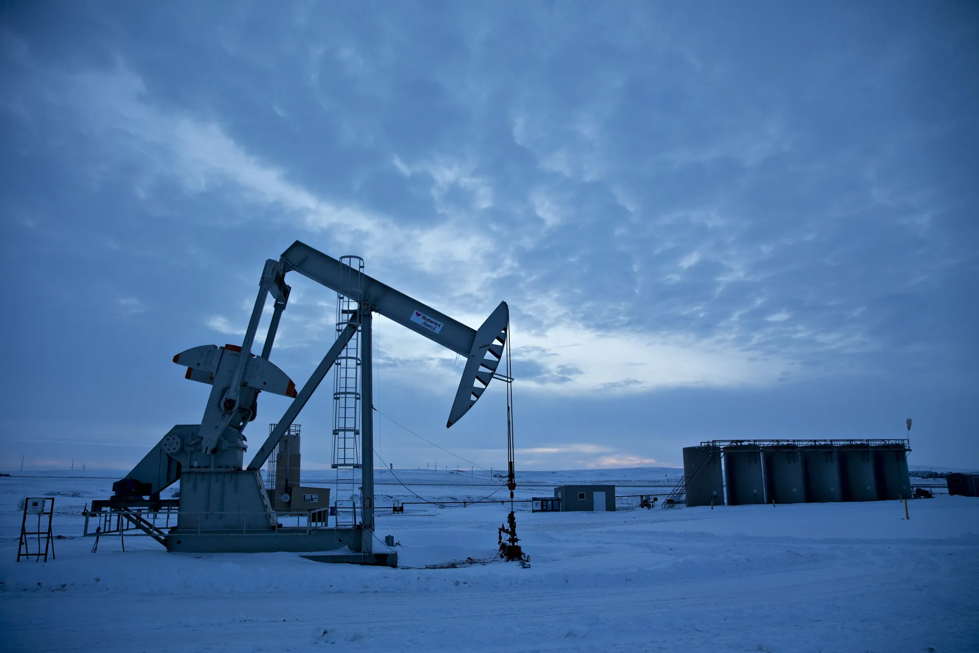 A pumpjack operates above an oil well in the Bakken Formation outside Williston, North Dakota.