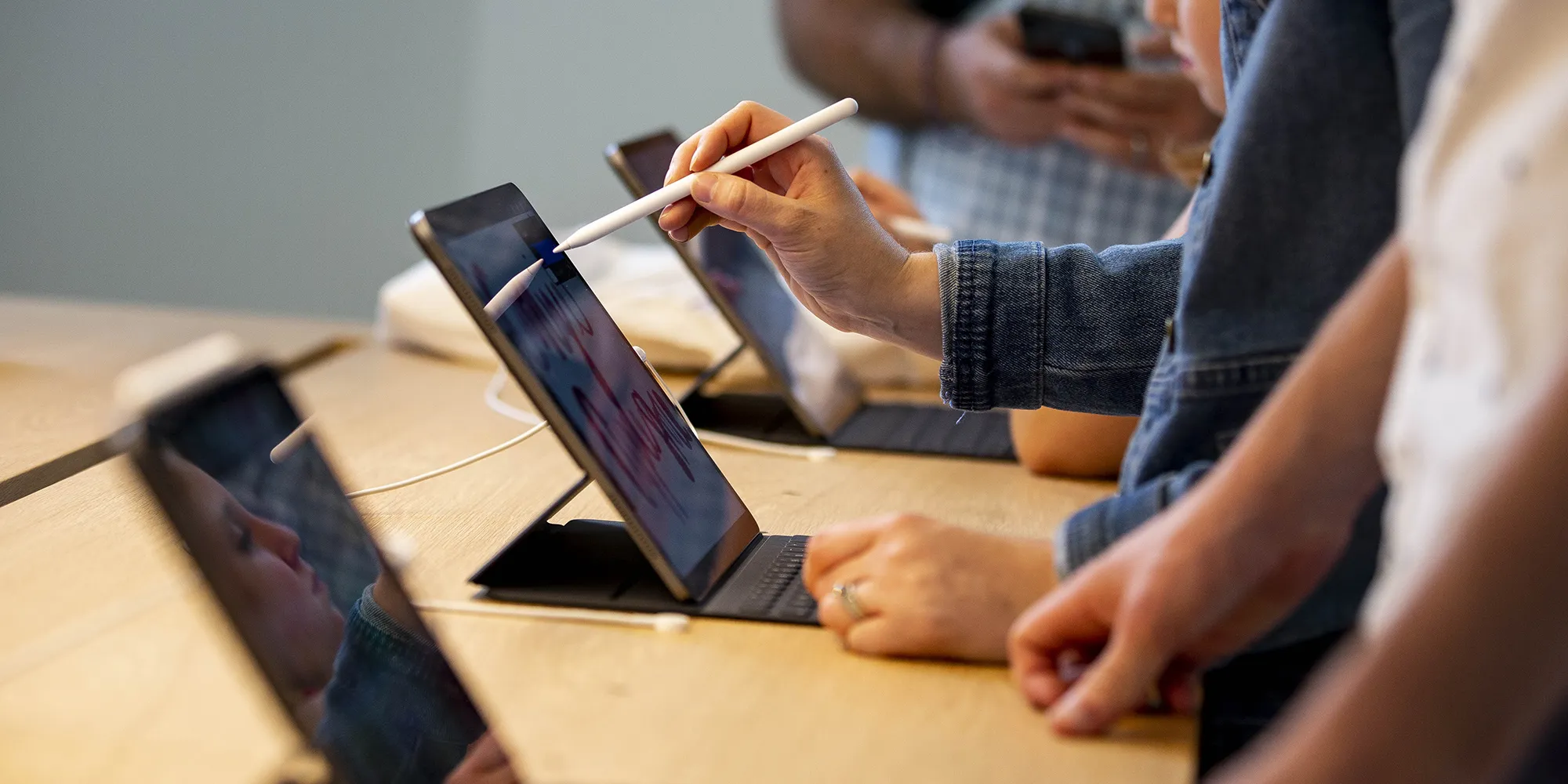 Attendees use a drawing program on an iPad tablet during the opening of the new Apple Inc. Carnegie Library store at Mount Vernon Square in Washington, D.C.
