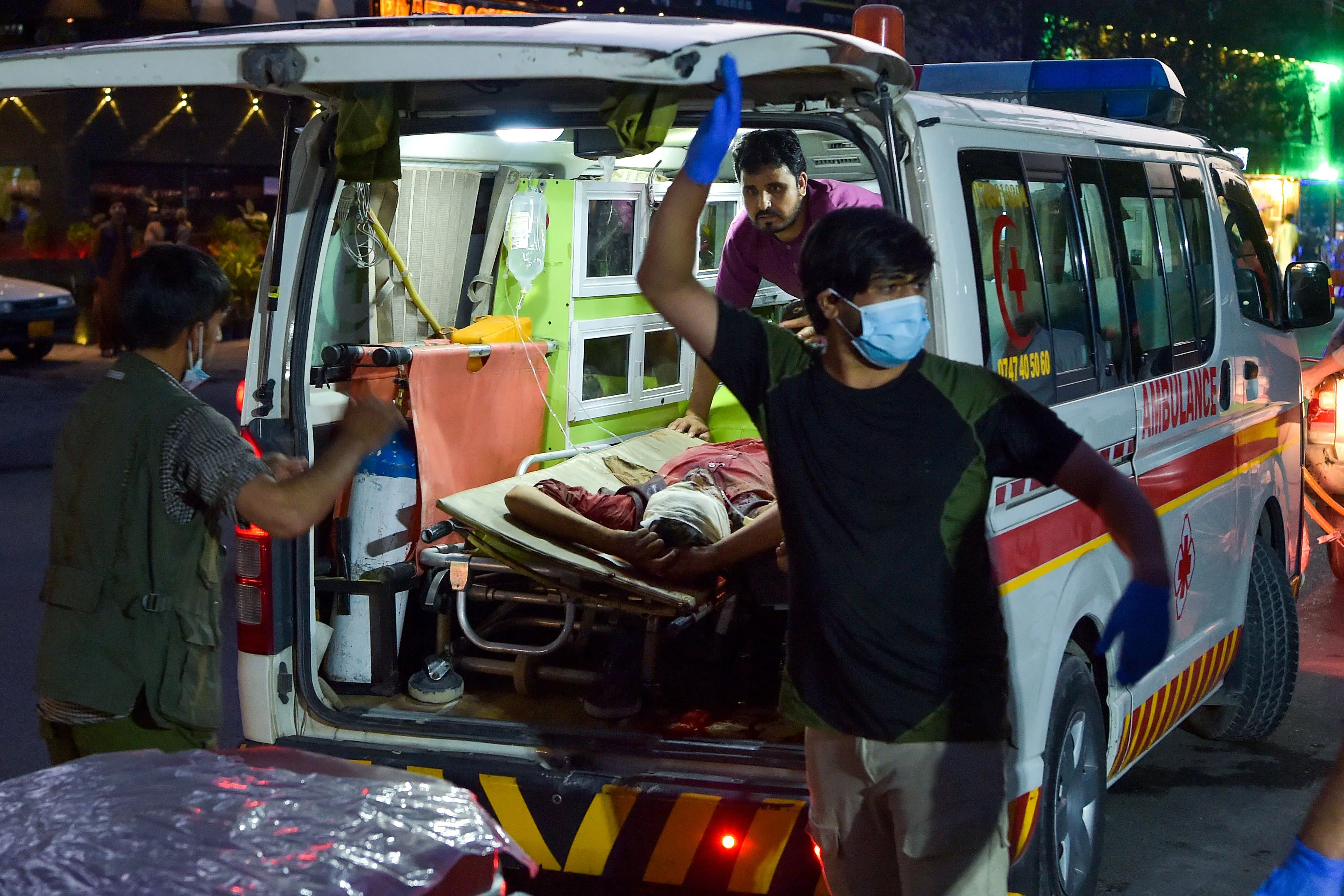 Medical staff bring an injured person to a hospital in Kabul, on Aug. 26.