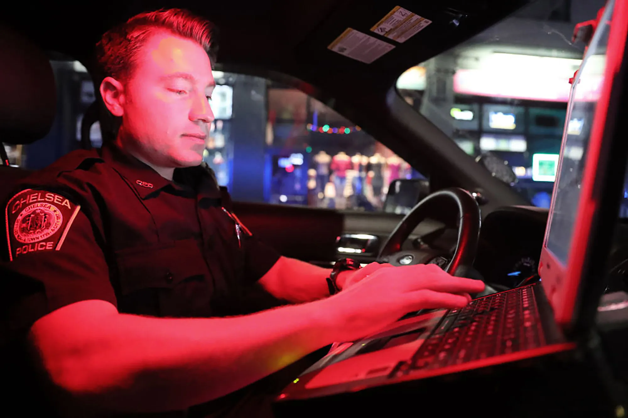 A Chelsea police "drug recognition expert," runs the license of a driver who failed to let a pedestrian cross the street in a cross walk in Chelsea, U.S.&nbsp;