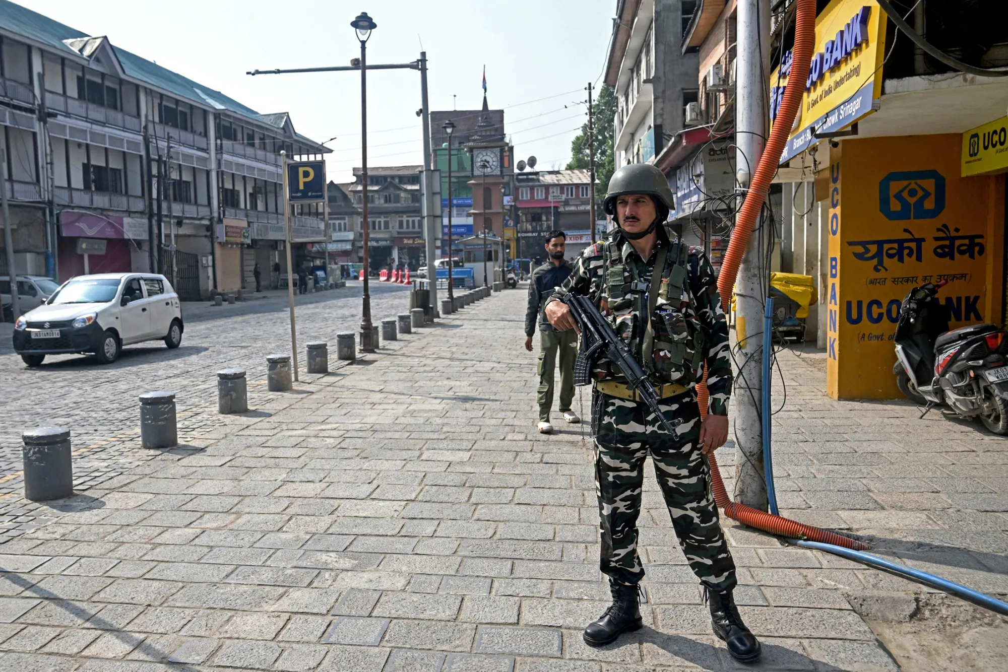 An Indian soldier stands guard near closed stores in Srinagar, Kashmir, on May 8.
