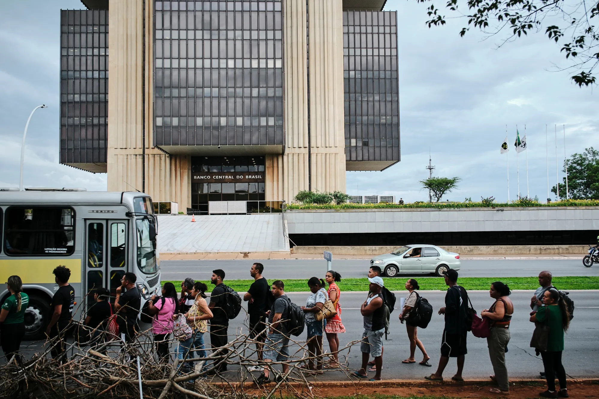 Commuters wait for a bus outside the Central Bank of Brazil in Brasilia.