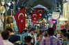 Customers browse souvenirs and other goods in the Grand Bazaar in Istanbul, Turkey, on Saturday, Aug. 15, 2015. Turkey’s central bank lowered the cost of dollar borrowing for a fourth time this year, seeking to halt the lira’s slide after the breakdown of talks on the formation of a new government sent financial markets tumbling.
