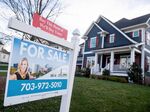 A house's real estate for sale sign is seen in front of a home in Arlington, Virginia, November 19, 2020. 
