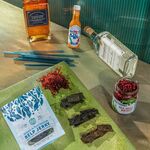 Seaweed is showing up in a wide range of new products (clockwise from top left:) Gunpowder &amp; Rose rum, Loliware straws, Bullwhip hot sauce, Sheringham gin, Atlantic Sea Farms “sea-beet kraut,” Akua’s kelp jerky, and Monterey Bay’s sea grapes.