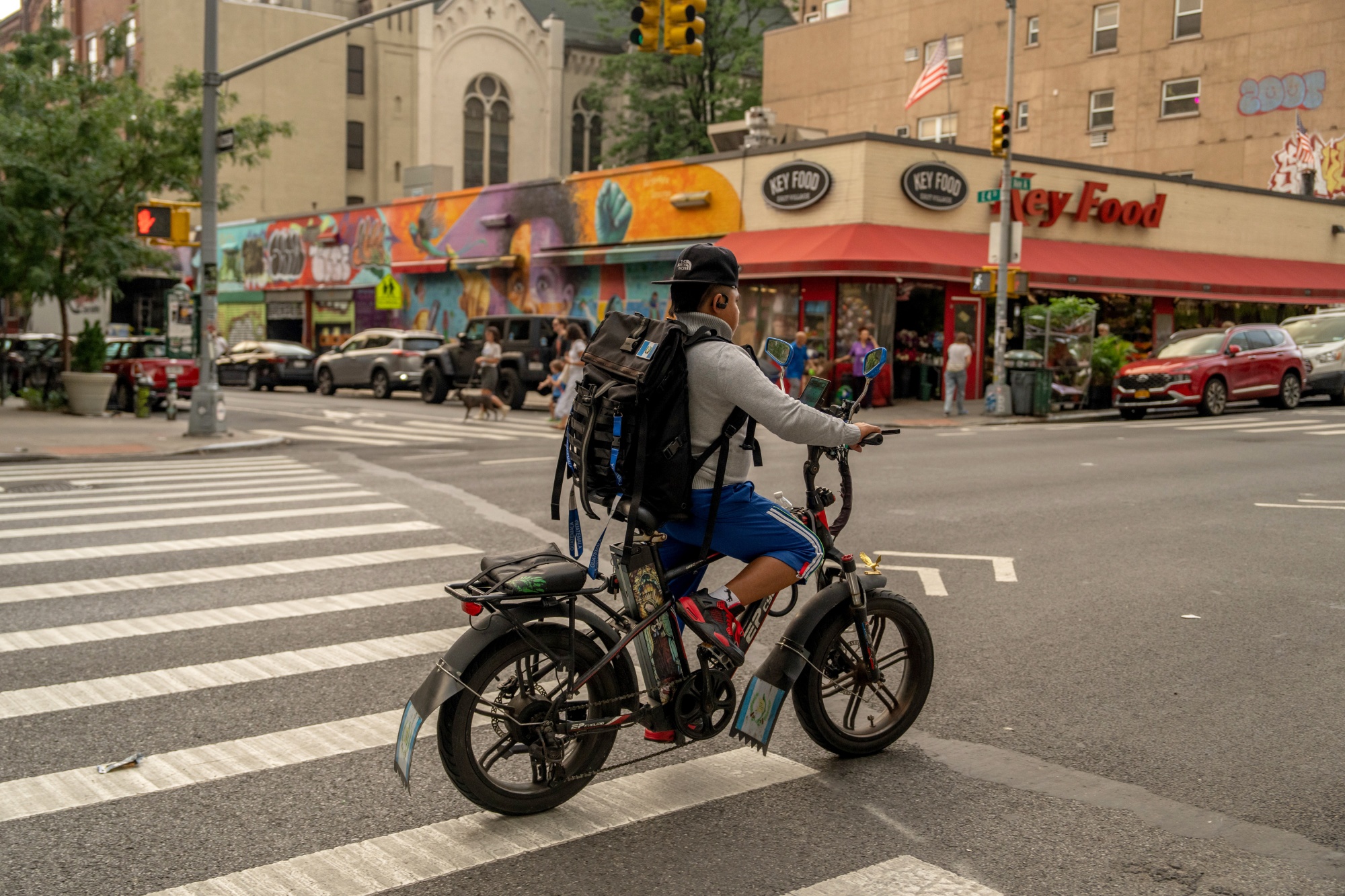 A cyclist rides an e-bike in New York, US, on Tuesday, July 23, 2024. New York Senator Kirsten Gillibrand said Monday that she's working to get federal legislation, which would require a safety standard for lithium-ion batteries used in electric bikes, included in the fiscal 2025 National Defense Authorization Act. Photographer: Adam Gray/Bloomberg